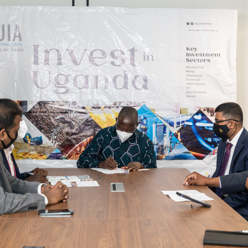 Ugandan Minsiter of Finance, Planning and Economic Development Matia Kasaija signs the investment deals at the special ceremony